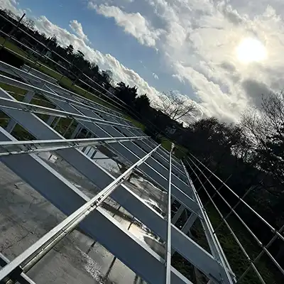 The sun is shining through the clouds in the sky.